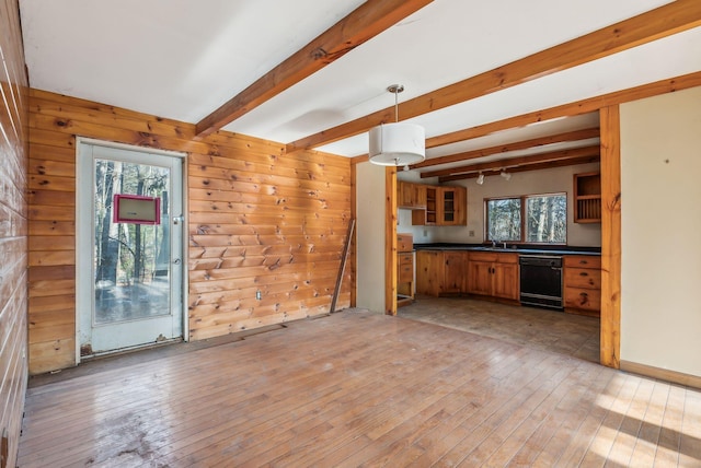 kitchen featuring light hardwood / wood-style floors, hanging light fixtures, dishwasher, and beamed ceiling