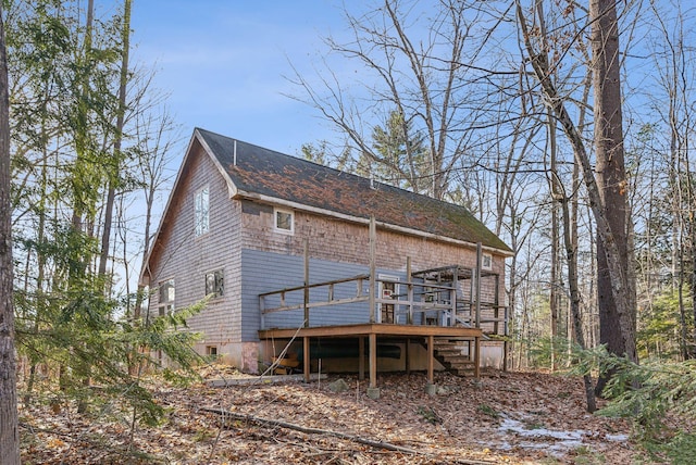 rear view of house with a wooden deck