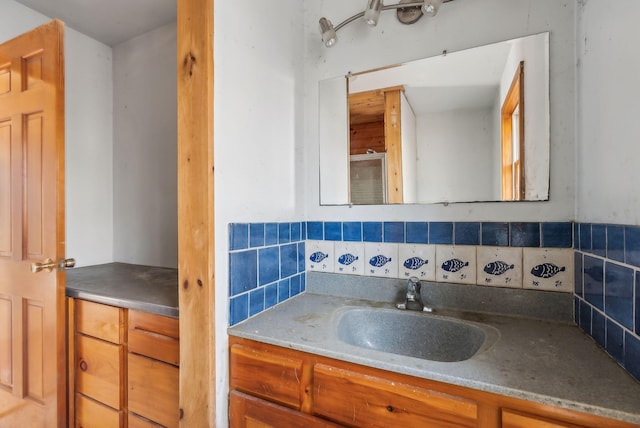 bathroom with vanity and tasteful backsplash