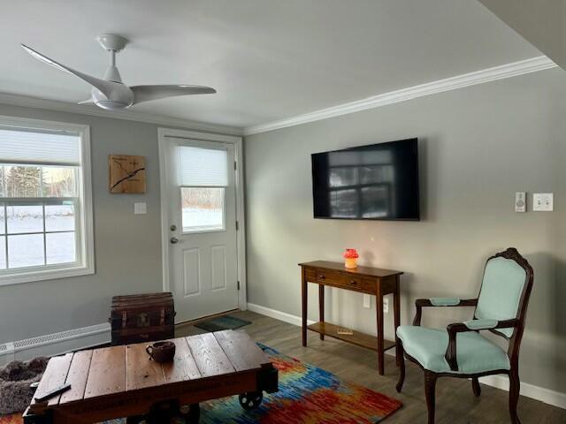 interior space with crown molding, ceiling fan, a healthy amount of sunlight, and hardwood / wood-style flooring