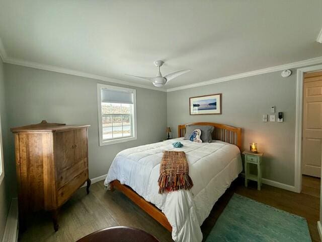 bedroom with dark hardwood / wood-style floors, ceiling fan, and ornamental molding