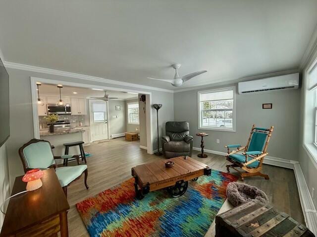 living area featuring ornamental molding, baseboard heating, a wall mounted AC, ceiling fan, and light hardwood / wood-style floors