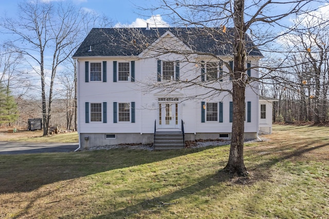 colonial-style house featuring a front lawn