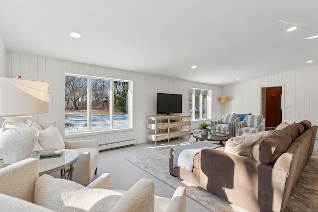 living room featuring baseboard heating and a wealth of natural light