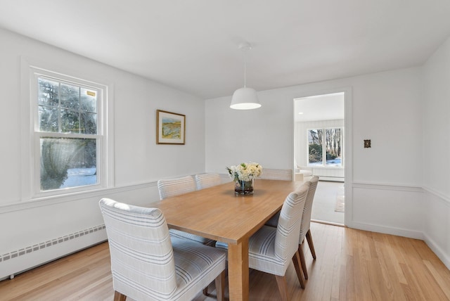 dining area featuring baseboard heating and light hardwood / wood-style floors