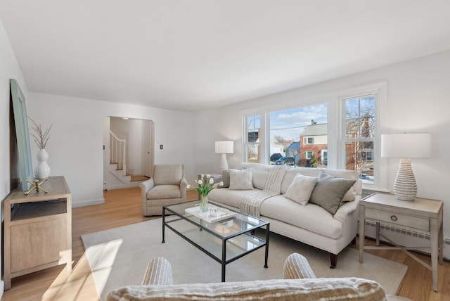 living room featuring baseboard heating and light wood-type flooring