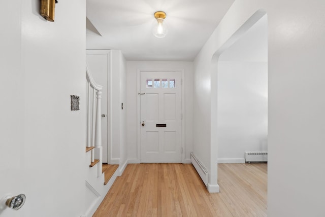 entryway featuring light wood-type flooring and a baseboard heating unit