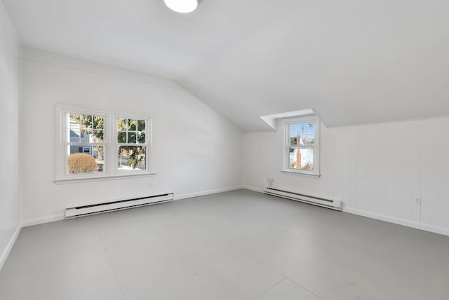 bonus room with a baseboard heating unit and vaulted ceiling