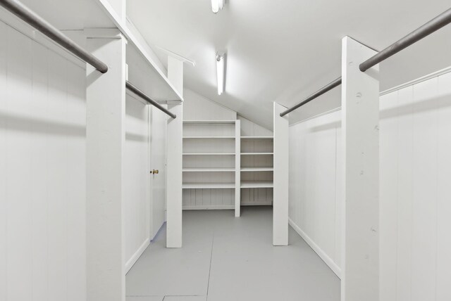 walk in closet featuring lofted ceiling