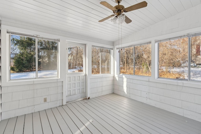 unfurnished sunroom featuring ceiling fan, a wealth of natural light, wooden ceiling, and lofted ceiling