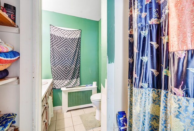 bathroom featuring tile patterned flooring, vanity, and toilet