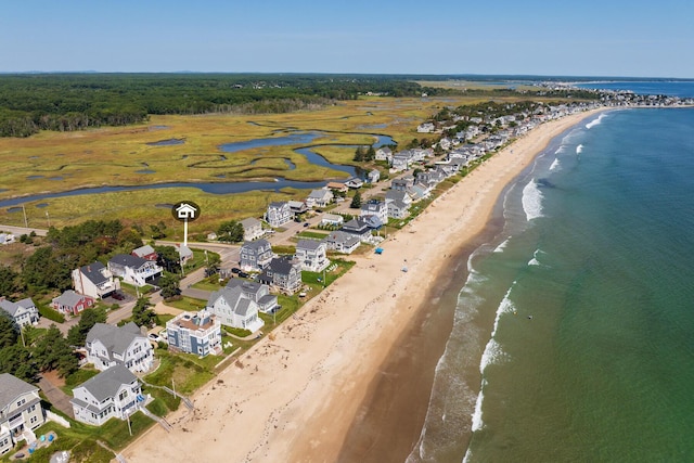 birds eye view of property featuring a water view and a beach view