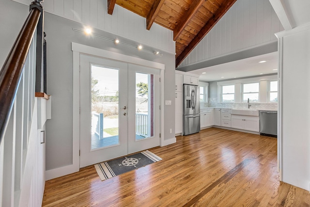 entryway featuring beam ceiling, sink, french doors, wood ceiling, and light wood-type flooring