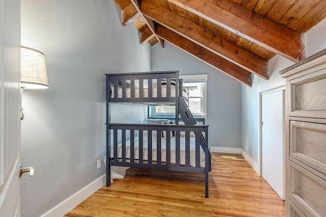 bedroom featuring wood ceiling, lofted ceiling with beams, and light hardwood / wood-style floors