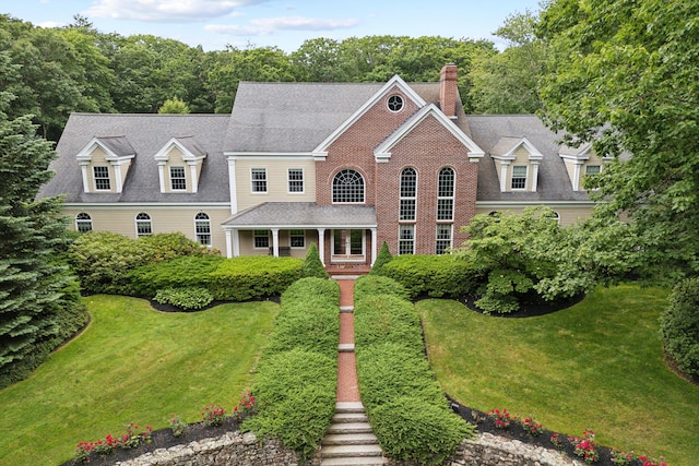 colonial home with a front lawn