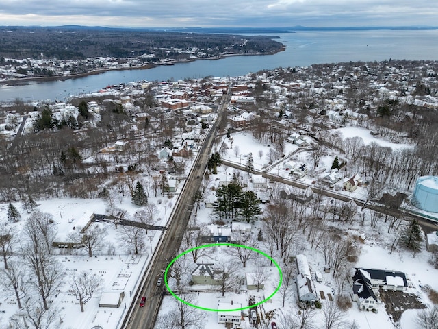 snowy aerial view featuring a water view