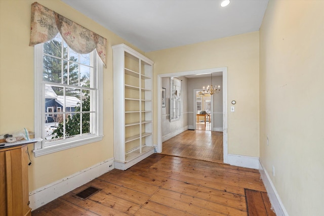 interior space with a chandelier and hardwood / wood-style flooring