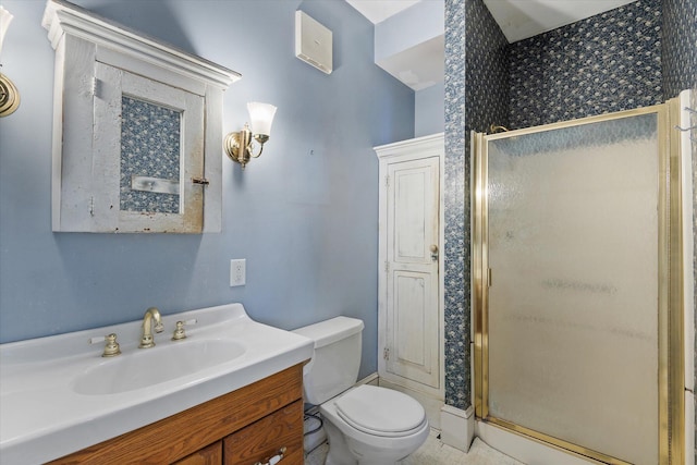 bathroom with vanity, an enclosed shower, and toilet