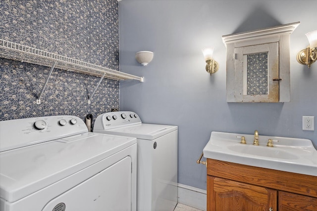 clothes washing area featuring independent washer and dryer and sink