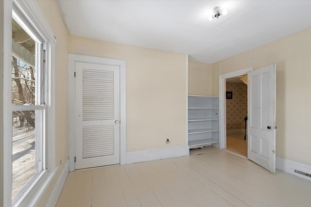 unfurnished bedroom with a closet and light hardwood / wood-style flooring