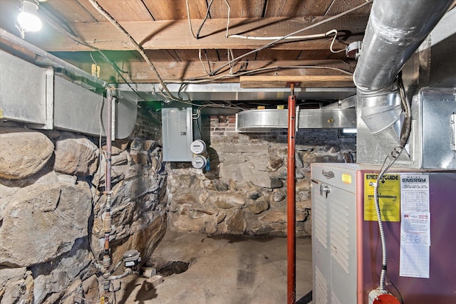 basement featuring electric panel and heating unit