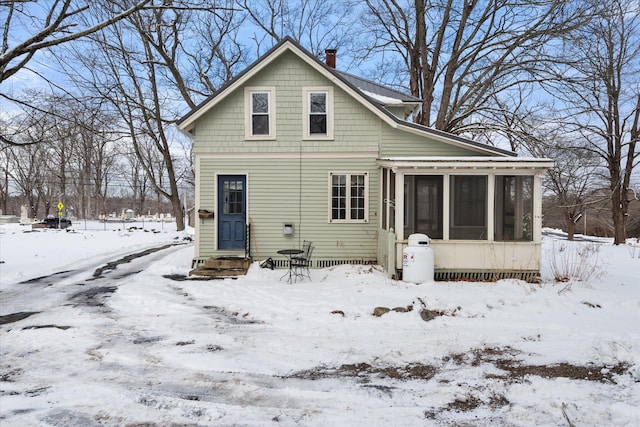 view of snow covered back of property