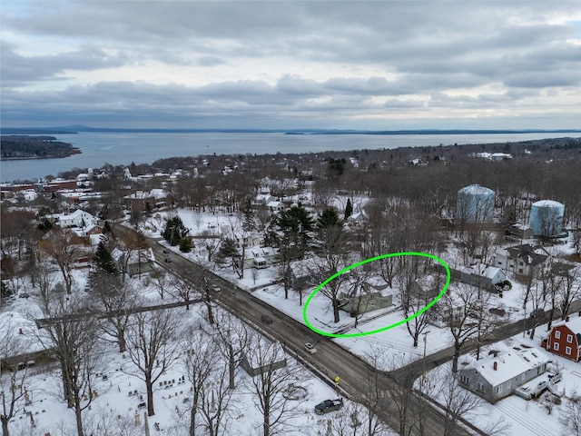 snowy aerial view featuring a water view