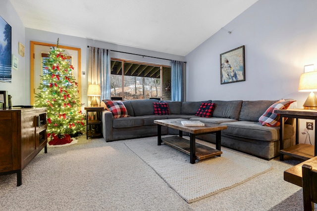 carpeted living room with lofted ceiling