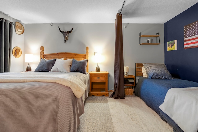 carpeted bedroom featuring a textured ceiling