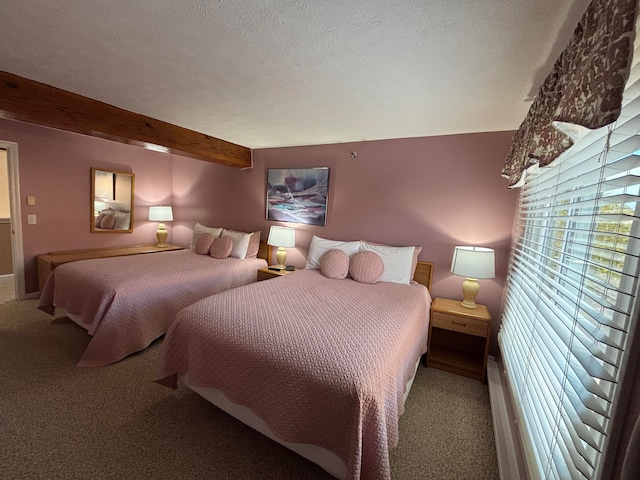 carpeted bedroom with beam ceiling and a textured ceiling