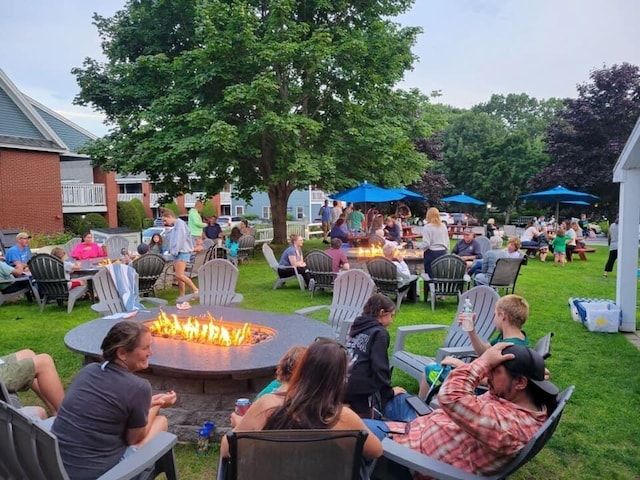 view of home's community featuring a fire pit and a lawn