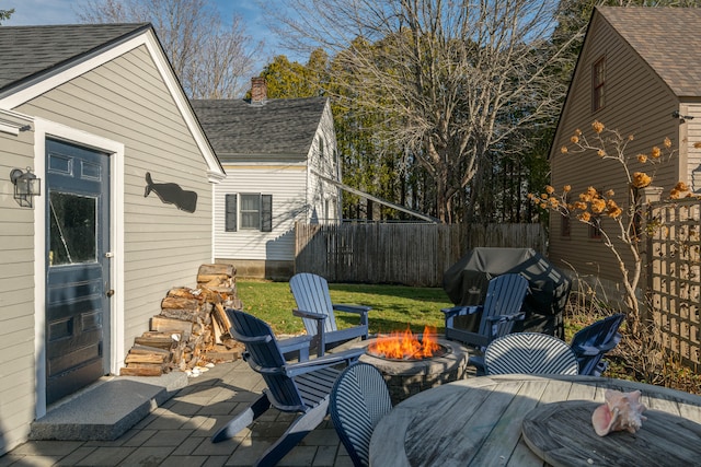 wooden deck with a grill, a yard, and a fire pit