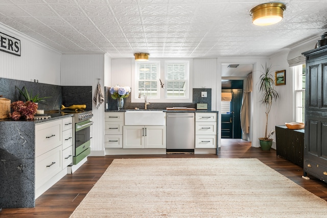 kitchen with dishwasher, backsplash, white cabinets, sink, and dark hardwood / wood-style floors