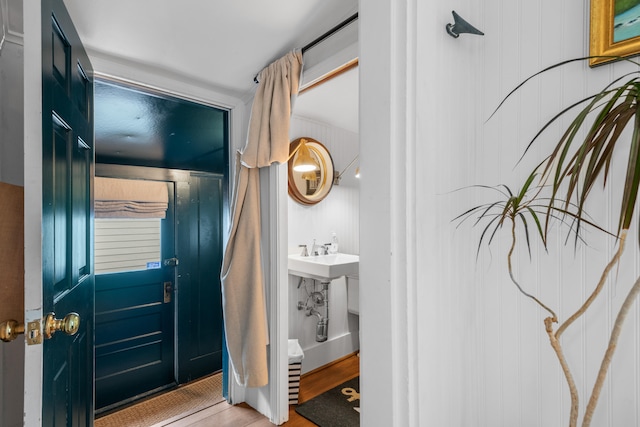 entryway with hardwood / wood-style floors and sink