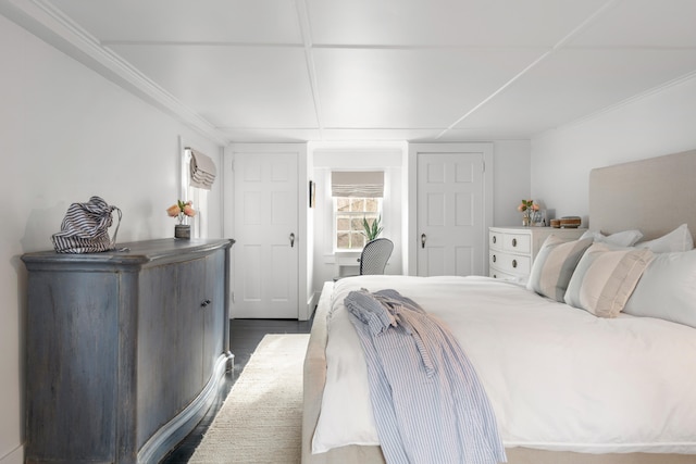 bedroom featuring hardwood / wood-style flooring and ornamental molding