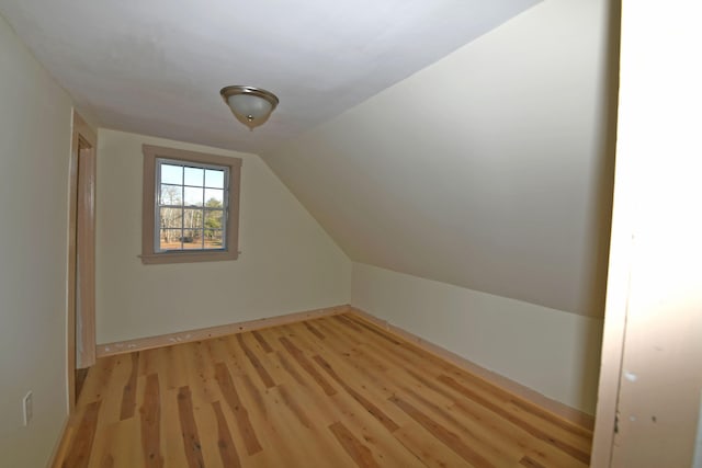 bonus room featuring light hardwood / wood-style flooring and vaulted ceiling