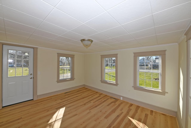 empty room featuring hardwood / wood-style floors and ornamental molding