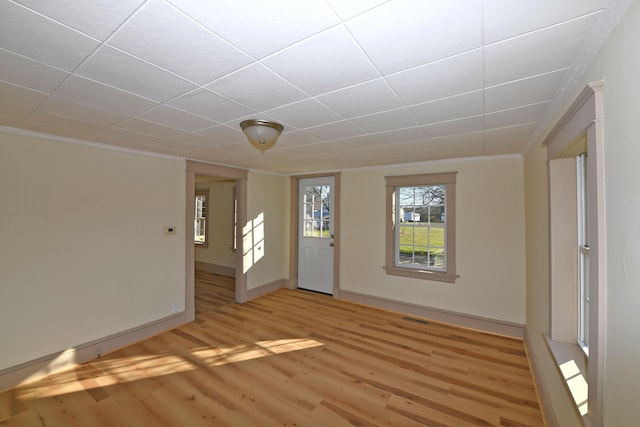 entrance foyer with crown molding and light wood-type flooring