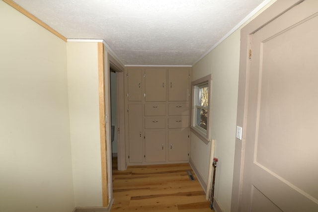 hallway featuring light hardwood / wood-style flooring and ornamental molding