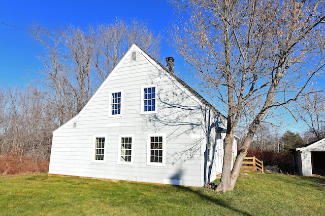 view of side of home featuring a yard