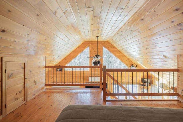 bonus room with wood walls, vaulted ceiling, wood-type flooring, and wooden ceiling