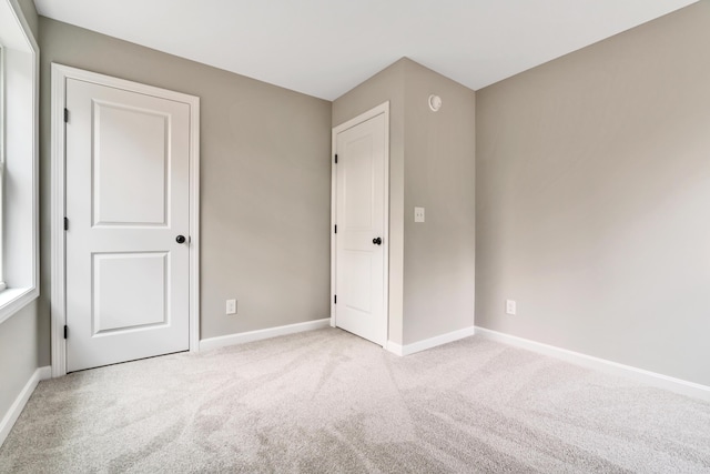 unfurnished bedroom featuring light carpet