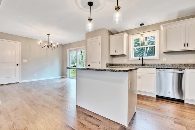 kitchen featuring white cabinetry, dishwasher, a kitchen island, and hanging light fixtures