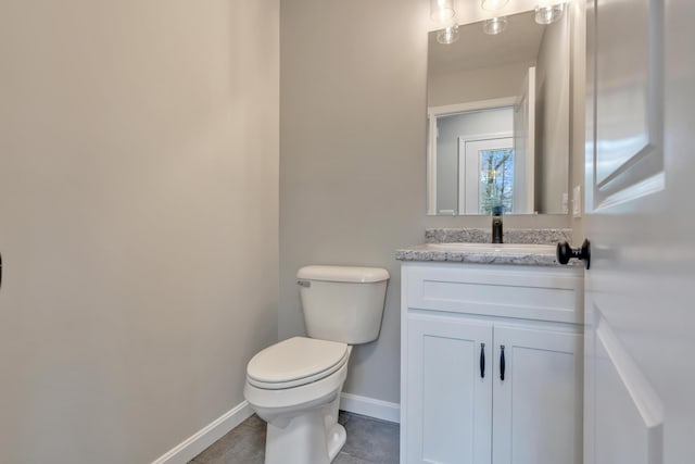 bathroom featuring tile patterned floors, vanity, and toilet