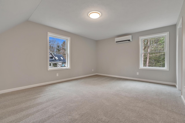 interior space with a wall mounted air conditioner, light colored carpet, and vaulted ceiling