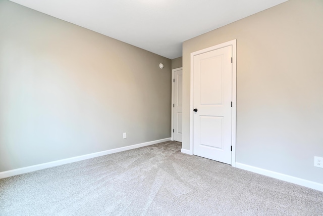 unfurnished room with light colored carpet