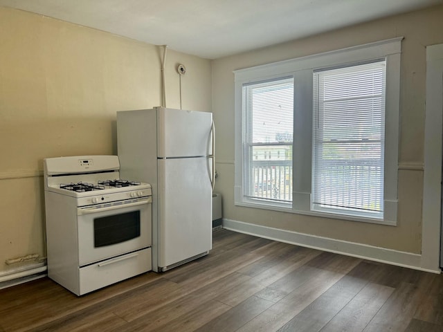 kitchen featuring dark hardwood / wood-style flooring and white appliances