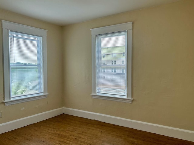 unfurnished room with wood-type flooring