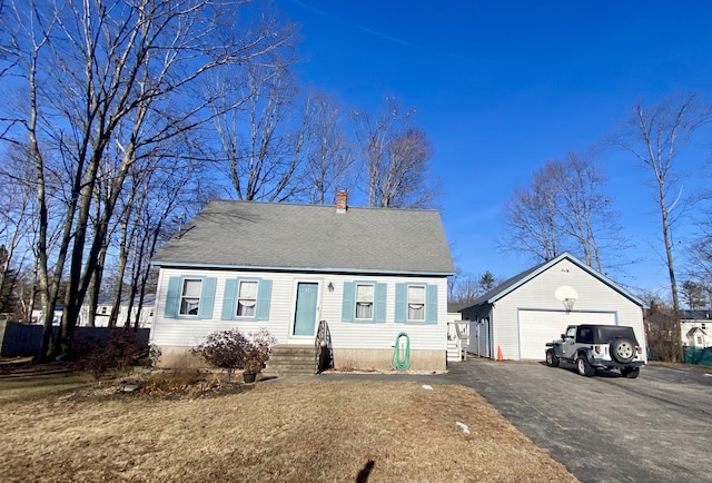 view of front of property featuring a garage and an outdoor structure