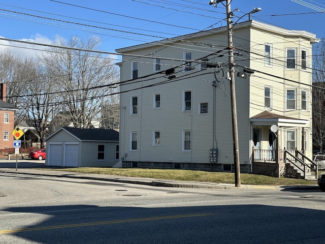 view of side of home with a garage and an outdoor structure